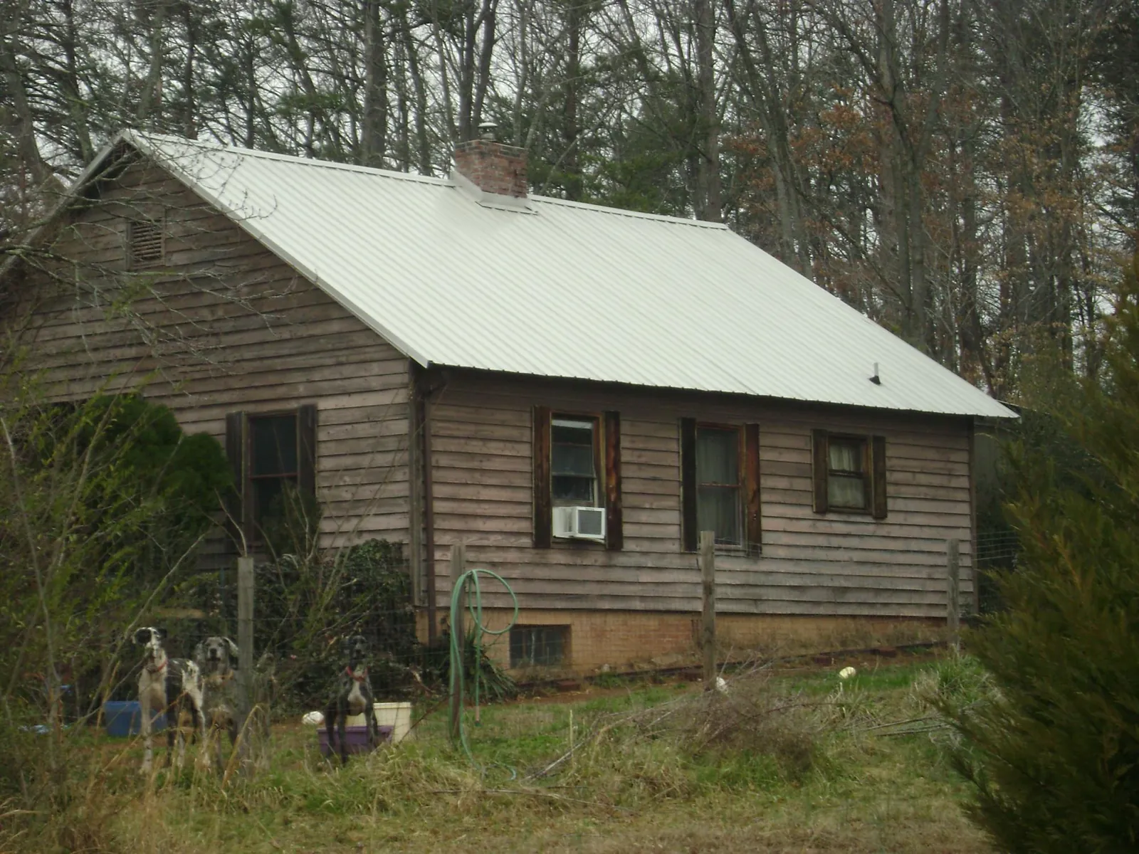 White metal roof on an old wood sided farmhouse, from a Metal Roof Installation job in Millry